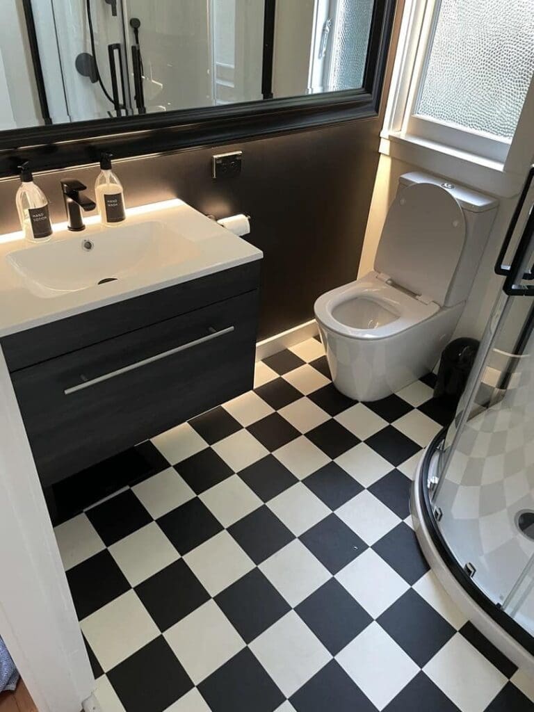 Bathroom renovation by regency plumbing - black and white